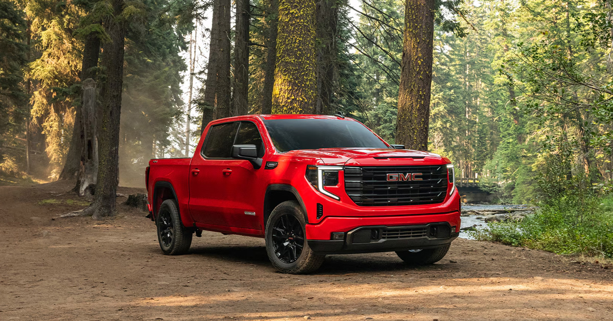 A red 2026 GMC Sierra 1500 parked in the woods